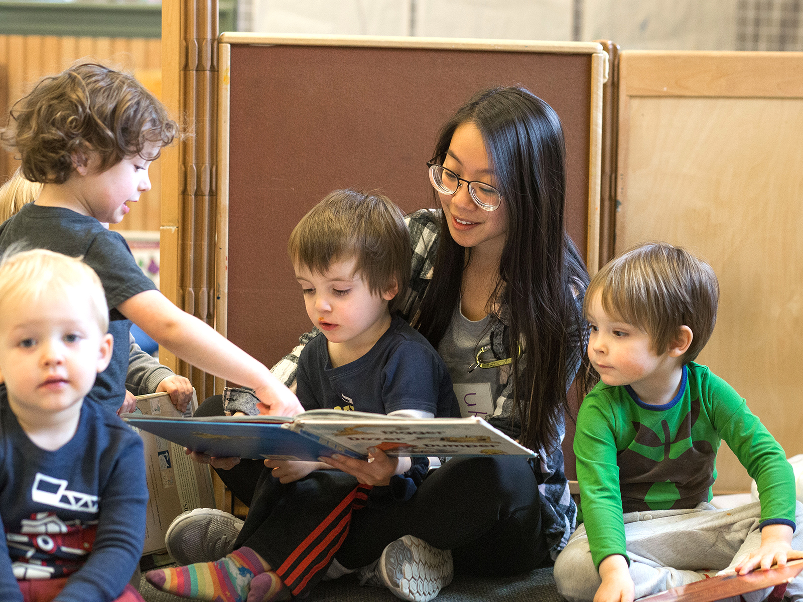 teacher reading to students 2_13 Teacher reading to her young students